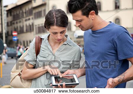 Young couple using digital tablet, Florence, Tuscany, Italy View Large Photo Image Stock Photo - Young couple using digital tablet, Florence, Tuscany, Italy. Fotosearch