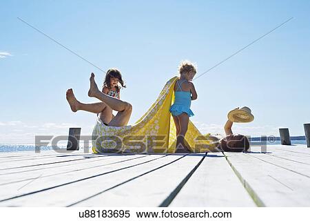 Young family fooling around on pier, Utvalnas, Gavle, Sweden View Large Photo Image Stock Photography - Young family fooling around on pier, Utvalnas, Gavle, Sweden. Fotosearch