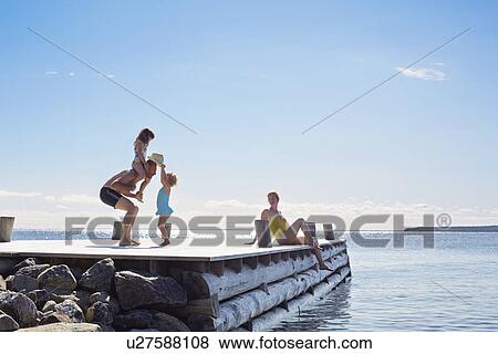 Stock Photo - Young family on pier, Utvalnas, Gavle, Sweden. Fotosearch