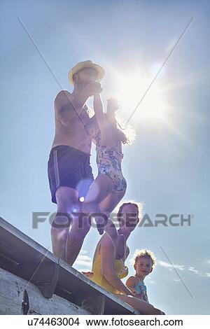 Young family playing on pier, Utvalnas, Gavle, Sweden View Large Photo Image Picture - Young family playing on pier, Utvalnas, Gavle, Sweden. Fotosearch