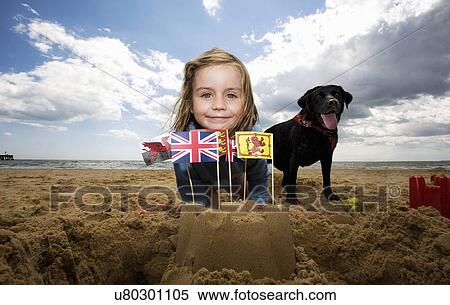 Young girl on with sandcastle on beach, Walberswick, Suffolk, England, UK View Large Photo Image Stock Photography - Young girl on with sandcastle on beach, Walberswick, Suffolk, England, UK. Fotosearch