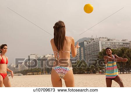 Young man and women playing volleyball on beach, Copacabana Beach, Rio De Janeiro, Brazil View Large Photo Image Stock Image - Young man and women playing volleyball on beach, Copacabana Beach, Rio De Janeiro, Brazil. Fotosearch