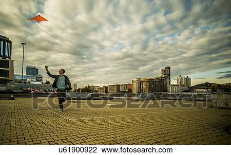 Young man flying kite, Russia View Large Photo Image Stock Image - Young man flying kite, Russia. Fotosearch