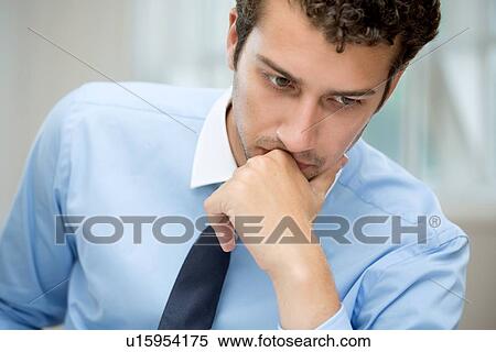 Stock Photography - Young man in deep thought. Fotosearch