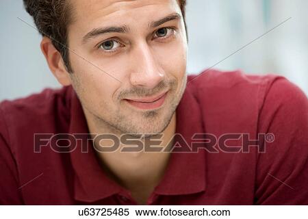 Young man looking at camera View Large Photo Image Stock Photography - Young man looking at camera. Fotosearch