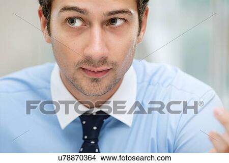 Picture - Young man looking away. Fotosearch