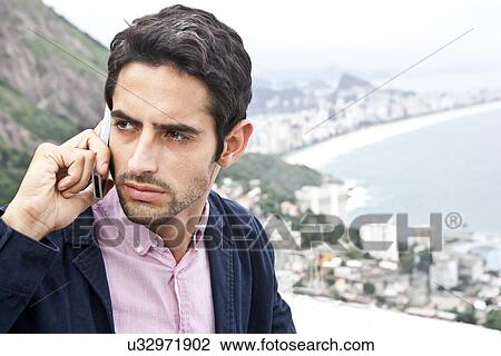 Young man on mobile, Casa Alto Vidigal, Rio De Janeiro, Brazil View Large Photo Image Stock Image - Young man on mobile, Casa Alto Vidigal, Rio De Janeiro, Brazil. Fotosearch