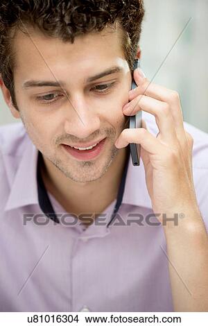Young man on mobile phone View Large Photo Image Picture - Young man on mobile phone. Fotosearch