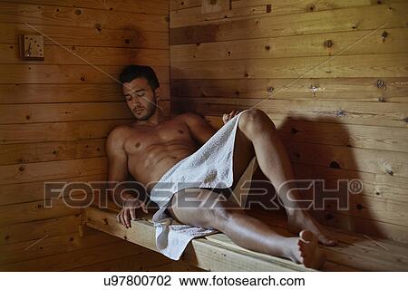 Young man reclining in sauna View Large Photo Image Stock Image - Young man reclining in sauna. Fotosearch