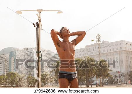 Young man showering on Copacabana Beach, Rio de Janeiro, Brazil View Large Photo Image Stock Photograph - Young man showering on Copacabana Beach, Rio de Janeiro, Brazil. Fotosearch