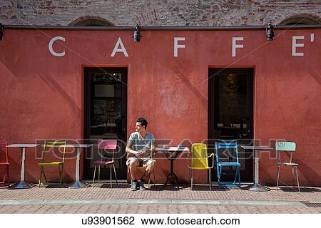 Young man sitting outside cafe, Florence, Tuscany, Italy View Large Photo Image Stock Image - Young man sitting outside cafe, Florence, Tuscany, Italy. Fotosearch