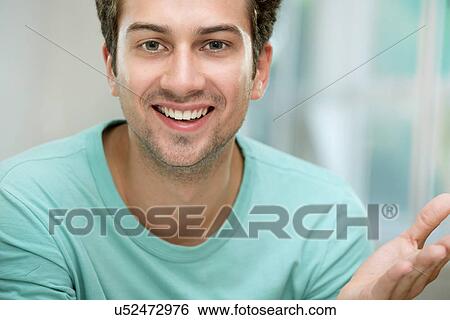 Stock Photograph - Young man smiling at camera. Fotosearch