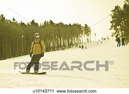 Young man snow boarding down mountain View Large Photo Image Stock Image - Young man snow boarding down mountain. Fotosearch