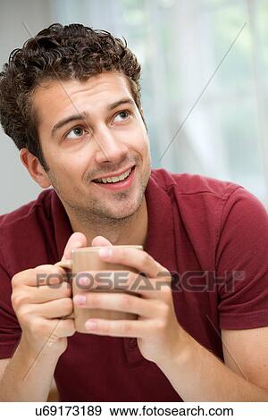 Young man taking coffee break View Large Photo Image Stock Photo - Young man taking coffee break. Fotosearch