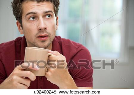Stock Photography - Young man taking coffee break. Fotosearch
