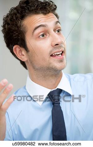 Stock Image - Young man talking. Fotosearch