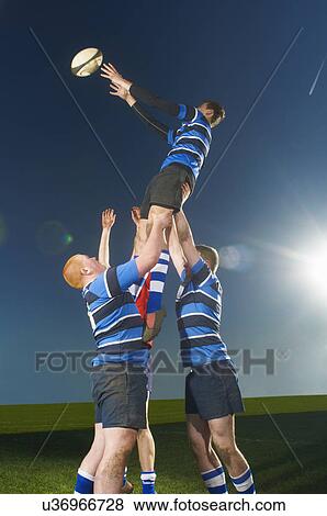 Stock Photo - Young men playing rugby. Fotosearch