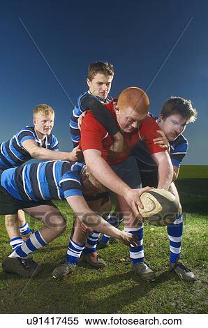 Stock Photography - Young men playing rugby. Fotosearch