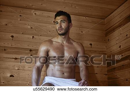 Young muscular man sitting in sauna View Large Photo Image Stock Image - Young muscular man sitting in sauna. Fotosearch