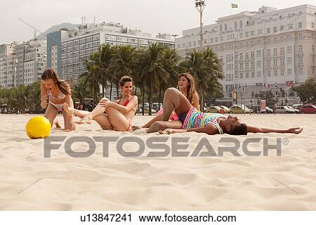 Young people relaxing on Copacabana Beach, Rio De Janeiro, Brazil View Large Photo Image Stock Image - Young people relaxing on Copacabana Beach, Rio De Janeiro, Brazil. Fotosearch