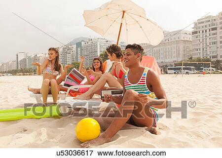 Young people relaxing on Copacabana Beach, Rio de Janeiro, Brazil View Large Photo Image Stock Photo - Young people relaxing on Copacabana Beach, Rio de Janeiro, Brazil. Fotosearch