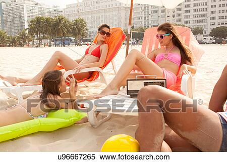 Stock Photography - Young people relaxing on Copacabana Beach, Rio De Janeiro, Brazil. Fotosearch