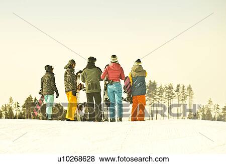 Young snow boarding friends watching from mountain View Large Photo Image Stock Photo - Young snow boarding friends watching from mountain. Fotosearch