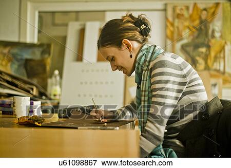 Stock Photo - Young woman drawing picture. Fotosearch