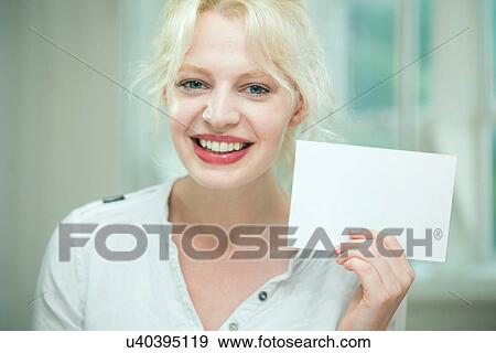 Young woman holding a blank card View Large Photo Image Stock Photo - Young woman holding a blank card. Fotosearch