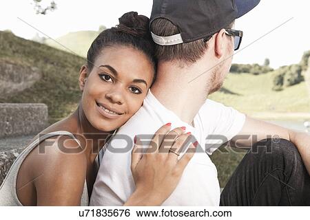Young woman hugging boyfriend View Large Photo Image Stock Photograph - Young woman hugging boyfriend. Fotosearch