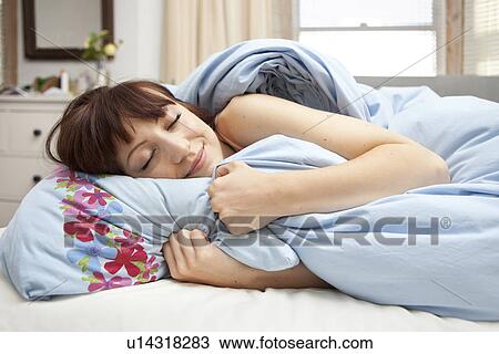 Young woman in bed with eyes closed View Large Photo Image Stock Image - Young woman in bed with eyes closed. Fotosearch