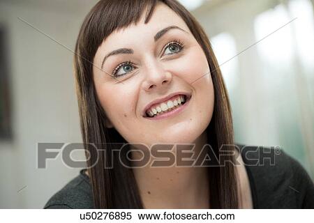 Stock Photography - Young woman looking up. Fotosearch