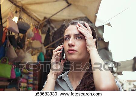 Young woman on cell phone, San Lorenzo market, Florence, Tuscany, Italy View Large Photo Image Stock Image - Young woman on cell phone, San Lorenzo market, Florence, Tuscany, Italy. Fotosearch