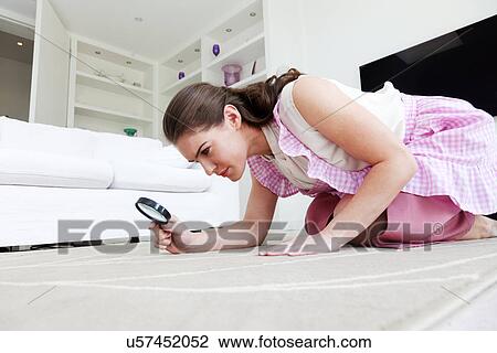 Young woman on hands and knees inspecting rug with magnifying glass View Large Photo Image Stock Image - Young woman on hands and knees inspecting rug with magnifying glass. Fotosearch