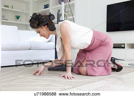 Young woman on hands and knees inspecting rug View Large Photo Image Stock Photo - Young woman on hands and knees inspecting rug. Fotosearch