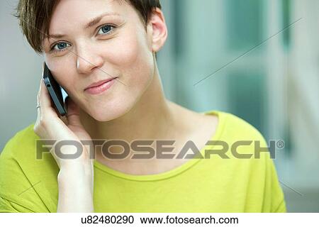 Young woman on mobile phone View Large Photo Image Stock Image - Young woman on mobile phone. Fotosearch