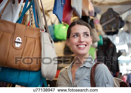 Stock Photo - Young woman shopping, San Lorenzo market, Florence, Tuscany, Italy. Fotosearch