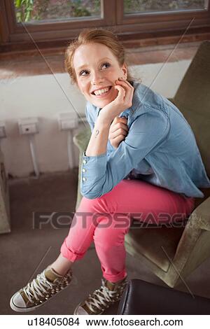 Young woman sitting with legs crossed View Large Photo Image Picture - Young woman sitting with legs crossed. Fotosearch
