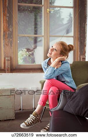 Young woman sitting with legs crossed View Large Photo Image Stock Photo - Young woman sitting with legs crossed. Fotosearch