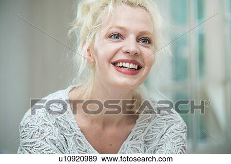 Young woman smiling and looking away View Large Photo Image Stock Photo - Young woman smiling and looking away. Fotosearch