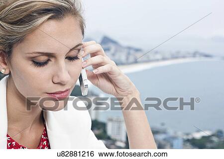 Young woman using mobile phone, Casa Alto Vidigal, Rio De Janeiro, Brazil View Large Photo Image Stock Photograph - Young woman using mobile phone, Casa Alto Vidigal, Rio De Janeiro, Brazil. Fotosearch