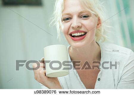 Young woman using with a coffee View Large Photo Image Stock Photograph - Young woman using with a coffee. Fotosearch