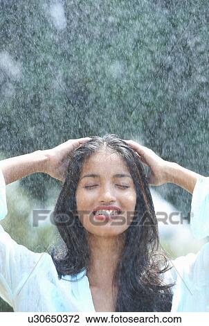 Young woman washing hair in rain View Large Photo Image Stock Image - Young woman washing hair in rain. Fotosearch