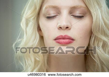 Stock Photograph - Young woman with eyes closed. Fotosearch