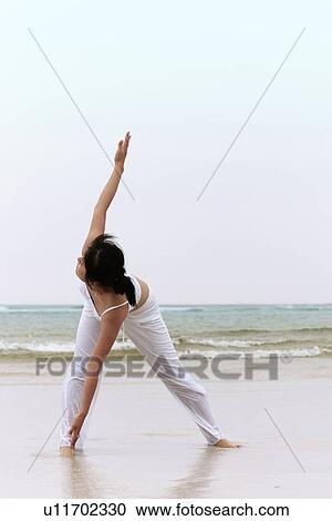 Stock Image - Beach, Exercising, Yoga, Body Care, Body Conscious, Fitness, Asian Ethnicity. Fotosearch