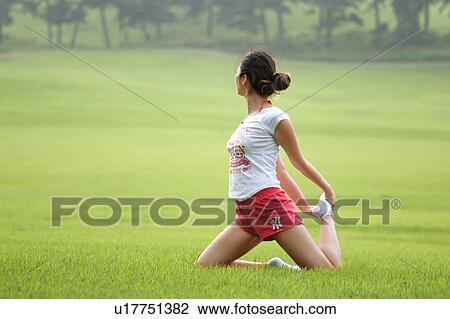 Stock Image - Beach, Exercising, Yoga, Body Care, Body Conscious, Fitness, Asian Ethnicity. Fotosearch