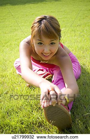 Stock Image - Beach, Exercising, Yoga, Body Care, Body Conscious, Fitness, Asian Ethnicity. Fotosearch
