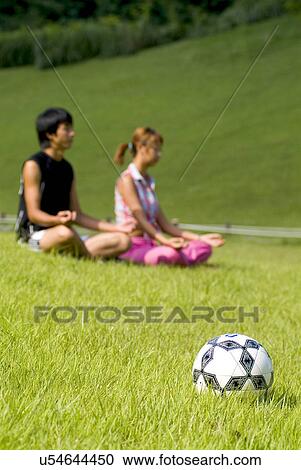 Stock Image - Beach, Exercising, Yoga, Body Care, Body Conscious, Fitness, Asian Ethnicity. Fotosearch