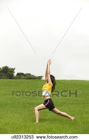 Stock Image - Beach, Exercising, Yoga, Body Care, Body Conscious, Fitness, Asian Ethnicity. Fotosearch