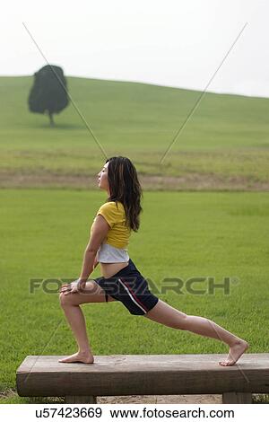 Stock Photo - Beach, Exercising, Yoga, Body Care, Body Conscious, Fitness, Asian Ethnicity. Fotosearch